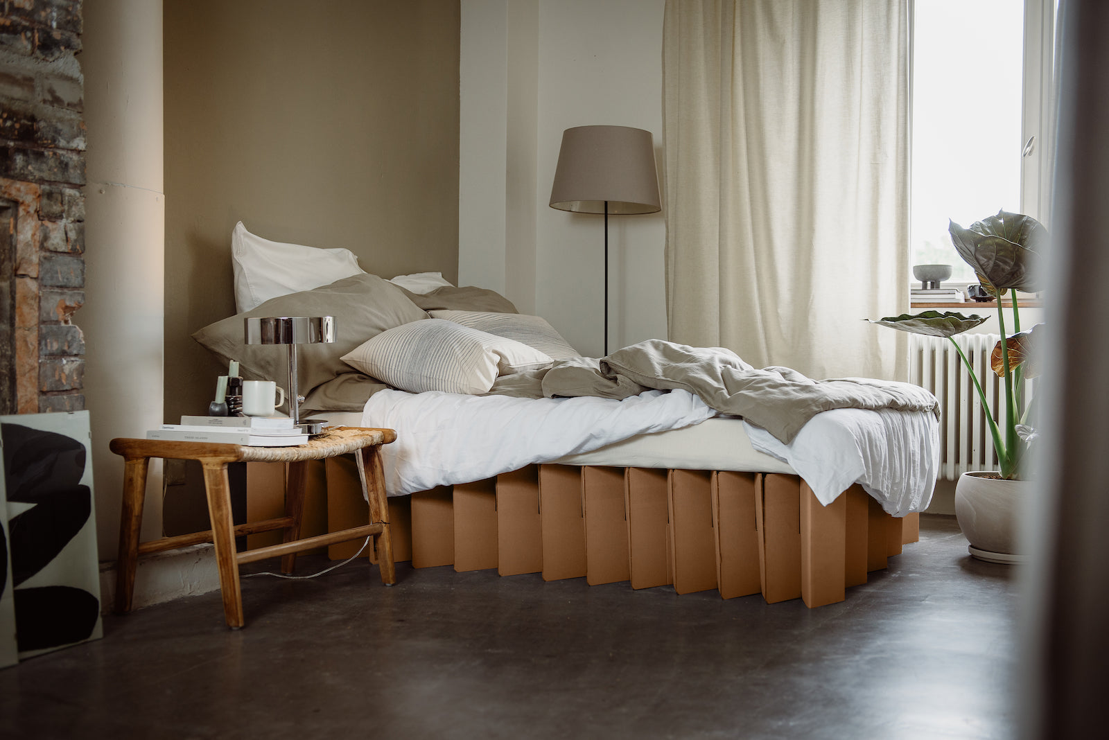 twin size Bett 2.0, a sustainable bed frame by RIAB USA, shown on in a room with primarily gray decor and white comforter